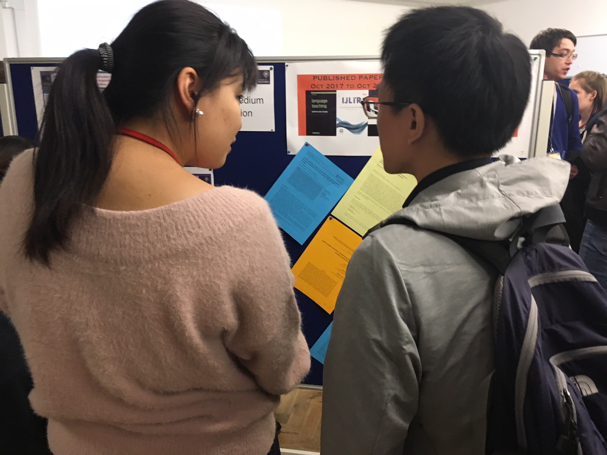 Two students reading research posters