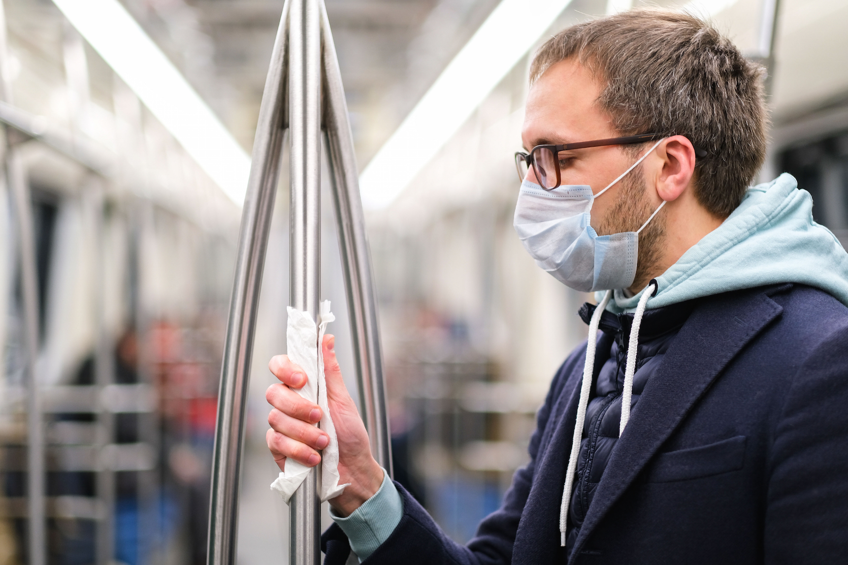 Man on the train wearing a face covering