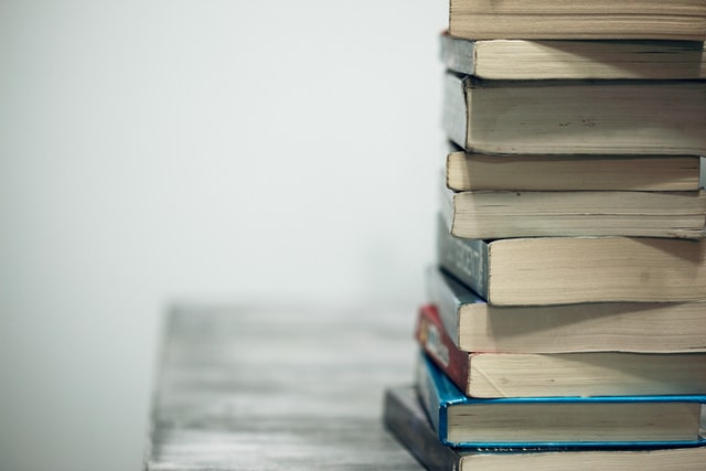 Books piled up on a desk