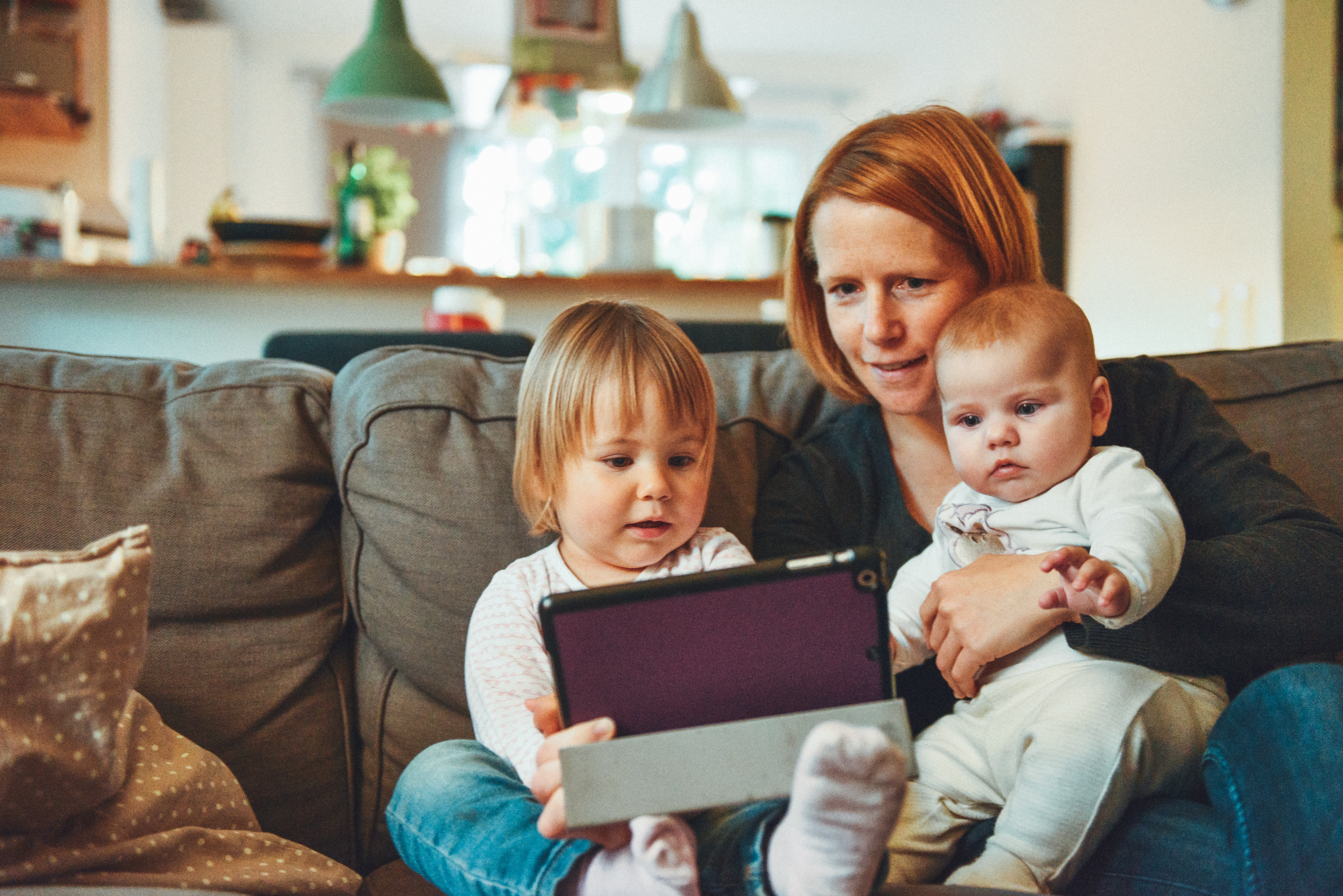 Mother and two children looking at phone