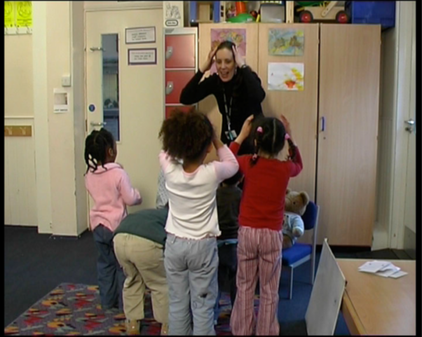 Teacher playing game with children